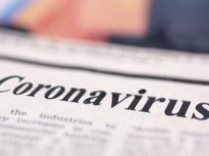Coronavirus written newspaper close up shot to the text.