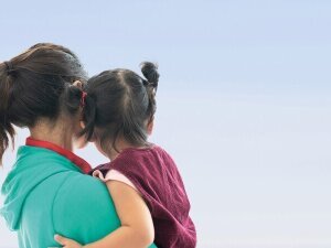 embracing a mother and a daughter, A lovely young girl embraces her mother.