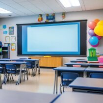 A clean, modern classroom with neatly arranged desks, a large interactive screen, and colorful wall decorations.
